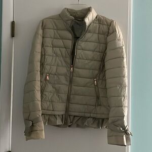 Down jacket with rose gold zippers and ties on the sleeves